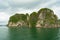 Halong Bay spectacular karst islands offset by tiny fishing boat