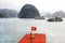 Halong Bay, Vietnam Landscapes, Vietnamese Flag in the foreground and signature Limestone Island in the Background