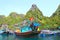 Halong Bay, Vietnam. Small Wooden Fishing boats docked at Floating Fishing village with Vietnam National Flag