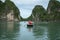 Halong bay in Vietnam, UNESCO World Heritage Site, with tourist rowing boats