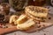 Halumi cheese with spices is sliced â€‹â€‹on a wooden board. Decorated with spices. In the background glass jars with spices and