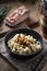 Halusky as traditional Slovak potato gnocchi with sheep cheese bryndza, fried bacon and chives