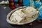 Halva with almond petals and tea on the kitchen table.