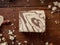 Halva cocoa tahini slice on wooden table background, top view