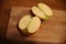 Halved apple on a wooden cutting board