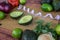 Halved avocado guacamole ingredients on wooden cutting board with measuring tape