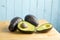 Halved avocado on kitchen table