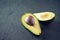 Halved Avocado on a Stone Background