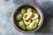 Halved avocados in the metal bowl