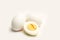 Halved boiled egg and two eggs