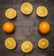 Halved oranges, lined frame wooden rustic background top view close up