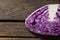 Halved purple cabbage on wooden table