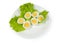 Halves of boiled chicken eggs on lettuce on dish