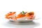 Halves of boiled eggs with pieces of salted salmon on white background