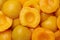 Halves of canned peaches as background, top view