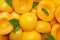 Halves of canned peaches with mint leaves as background, top view