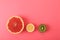 Halves of delicious juicy exotic fruits on background, flat lay