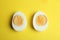 Halves of fresh hard boiled chicken egg on background, flat lay