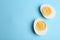 Halves of fresh hard boiled chicken egg on blue background, flat lay. Space for text