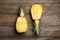 Halves of fresh pineapple on wooden background