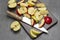 Halves a green apple. Slices of green and red apples and kitchen knife on cutting board