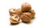 Halves and a pile of walnuts on a white background focus on half