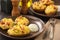 Ham and cheese jacket potatoes on dark background.