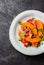 Ham jamon, melon and arugula salad on grey plate