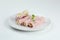 Ham roll with cheese and microgreen on white plate. mortadella and ricotta rolls isolated on white background