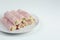 Ham roll with cheese on white plate. mortadella and ricotta rolls isolated on white background