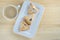 Hamantaschen cookies and Cup of coffee on white dish on wood desk background. Purim holiday celebration.Top view.
