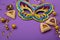 Hamantaschen Cookies, Triangular Pastry, Carnival Mask, Noisemaker on Purple Background. Purim Celebration, Jewish Carnival