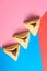 Hamantash filled-pocket cookie recognizable for triangular shape for Jewish holiday of Purim on red and blue background.