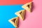 Hamantash filled-pocket cookie recognizable for triangular shape for Jewish holiday of Purim on red and blue background.