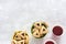 Hamantashen cookies or Aman ears, triangular cookies with poppy seeds in two colored buckets on gray background and hot tea in pap