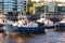 Hamburg, Germany - April 30th, 2023: Many modern powerful tow ships service team mored in row at Hamburg Elbe harbour at