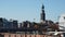 Hamburg Skyline with historic St. Michael's Church, aka Michel, and metro train crossing on a sunny day against a