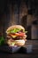 Hamburger with bacon, turkey burger meat, cheese, tomato and lettuce