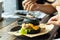 Hamburger black pork on the plate on a wooden table.