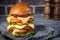 Hamburger with a double serving of meat, tomatoes, salad, onions on a wooden board in a restaurant.Copy space