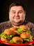 Hamburger eating fast food contest. Fat man eating fast food.