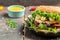 Hamburger with feta cheese and chicken beef on a wooden table. symbol of diet temptation resulting in unhealthy nutrition. place