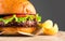 Hamburger with fries rotated on wooden table background. Cheeseburgers on fresh buns with succulent beef and fresh salad