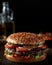 Hamburger illustration for advertising, dark background to highlight the hamburger. Professional lighting makes the meat look so