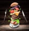 Hamburger ingredients falling down one by one to create a perfect meal. Colorful conceptual picture of burger cooking