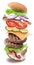 Hamburger ingredients falling down one by one to create a perfect meal. Colorful conceptual picture of burger cooking. Clipping