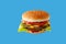 hamburger like in McDonald\\\'s with a beef cutlet on a blue background, studio shooting 3
