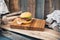 Hamburger in the original bun is on a thick oak board. Rustic surroundings in a dark composition.