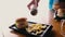 Hamburger Plate with French Fries and Woman Putting Salt on the French Fries