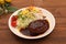 Hamburger steak with demi-glace sauce served on a plate